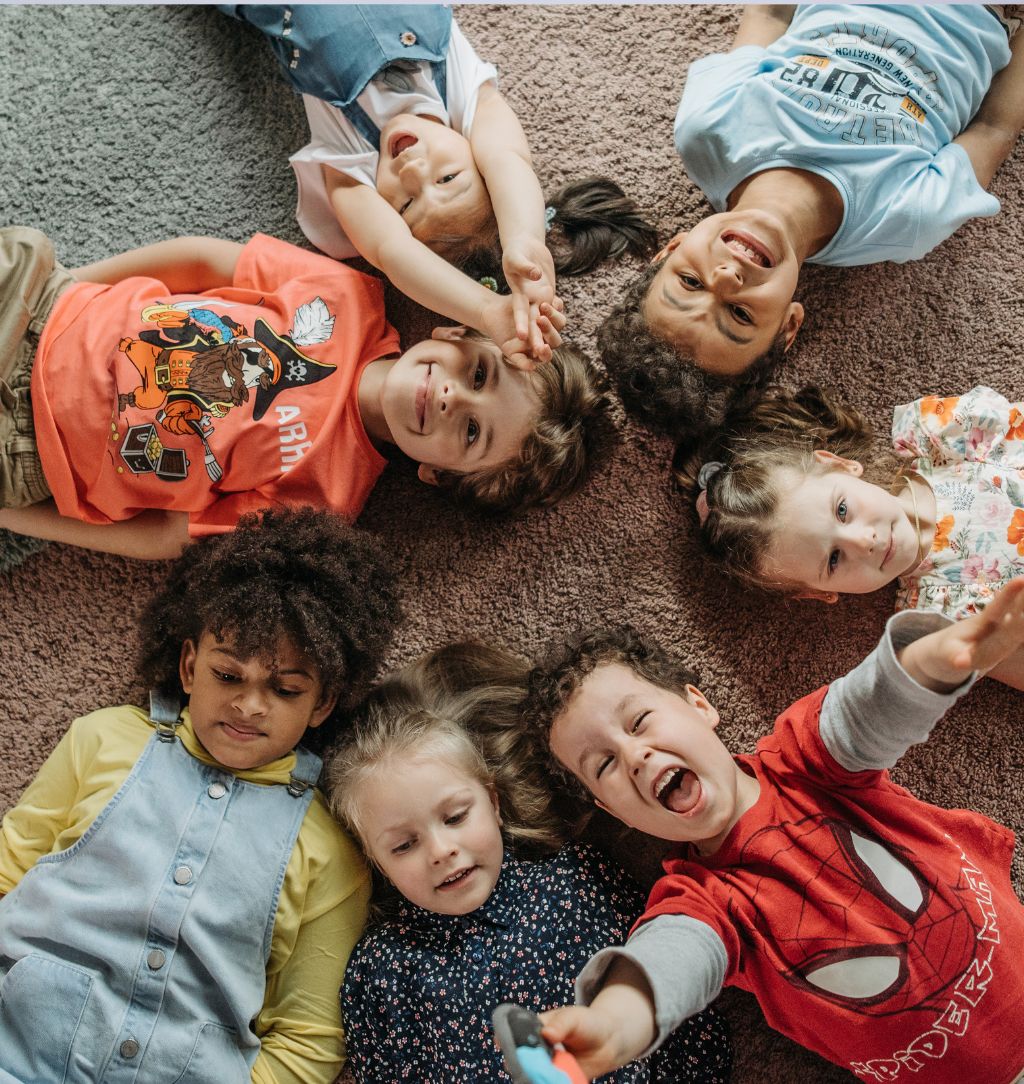children lying on carpet